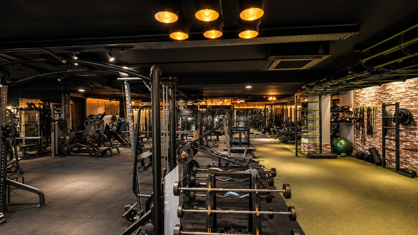 A long run of dumbbell racks and benches at V2 Fitness Zone Sainikpuri