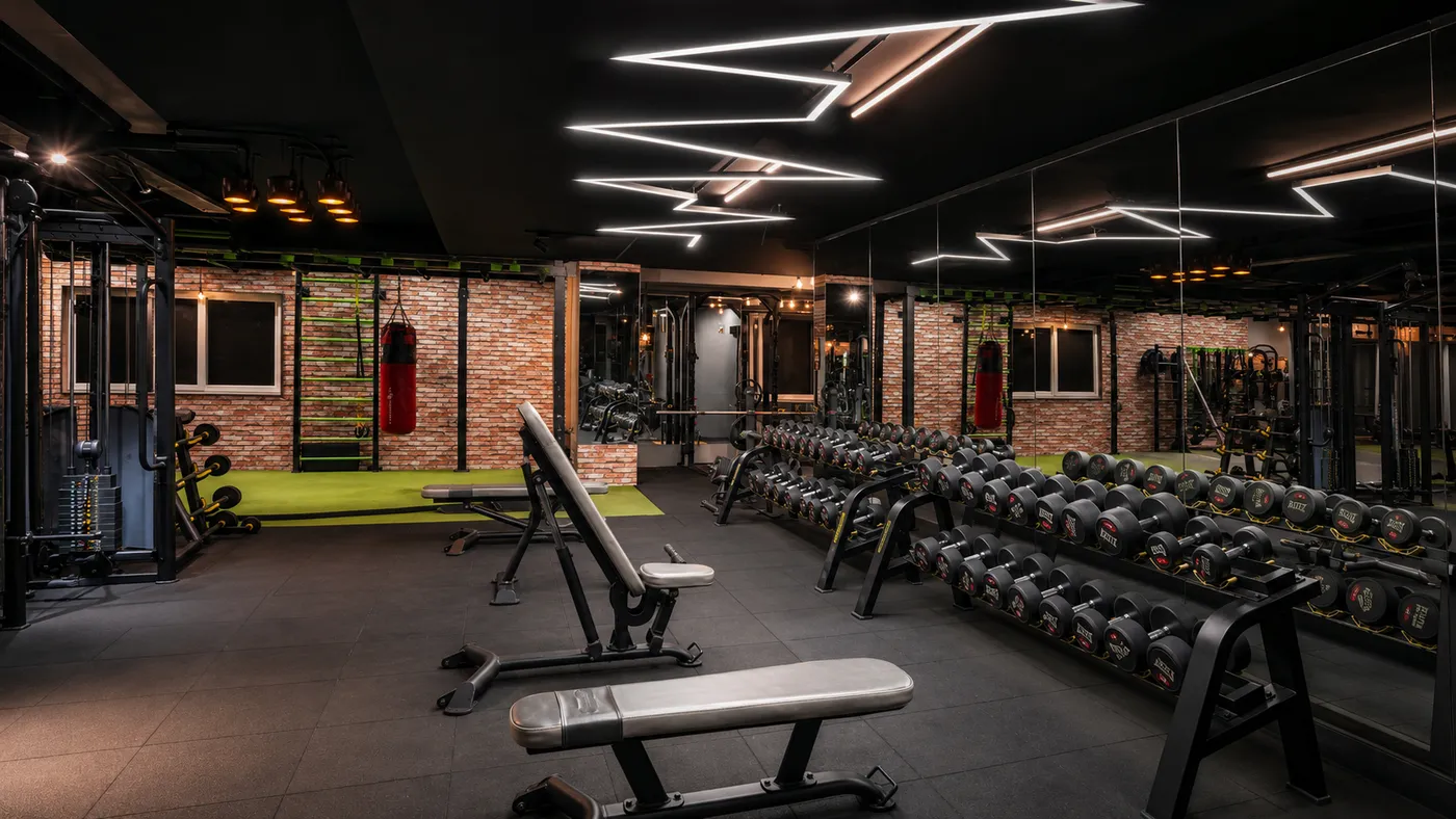 Dumbbell racks and flat benches on the strength floor at V2 Fitness Zone Sainikpuri